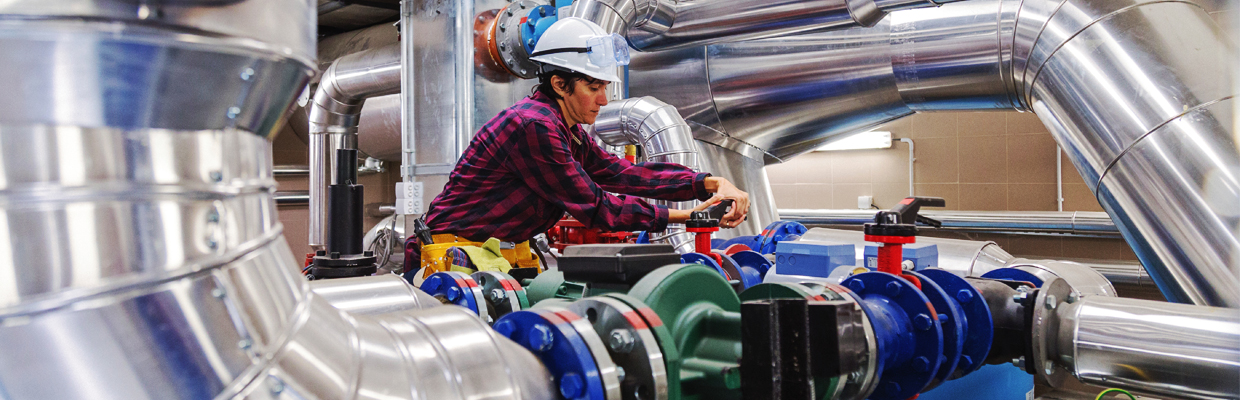 Woman duct worker maintaining pipes